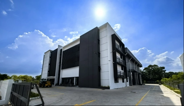 TRIDENT company factory exterior with a paved forecourt